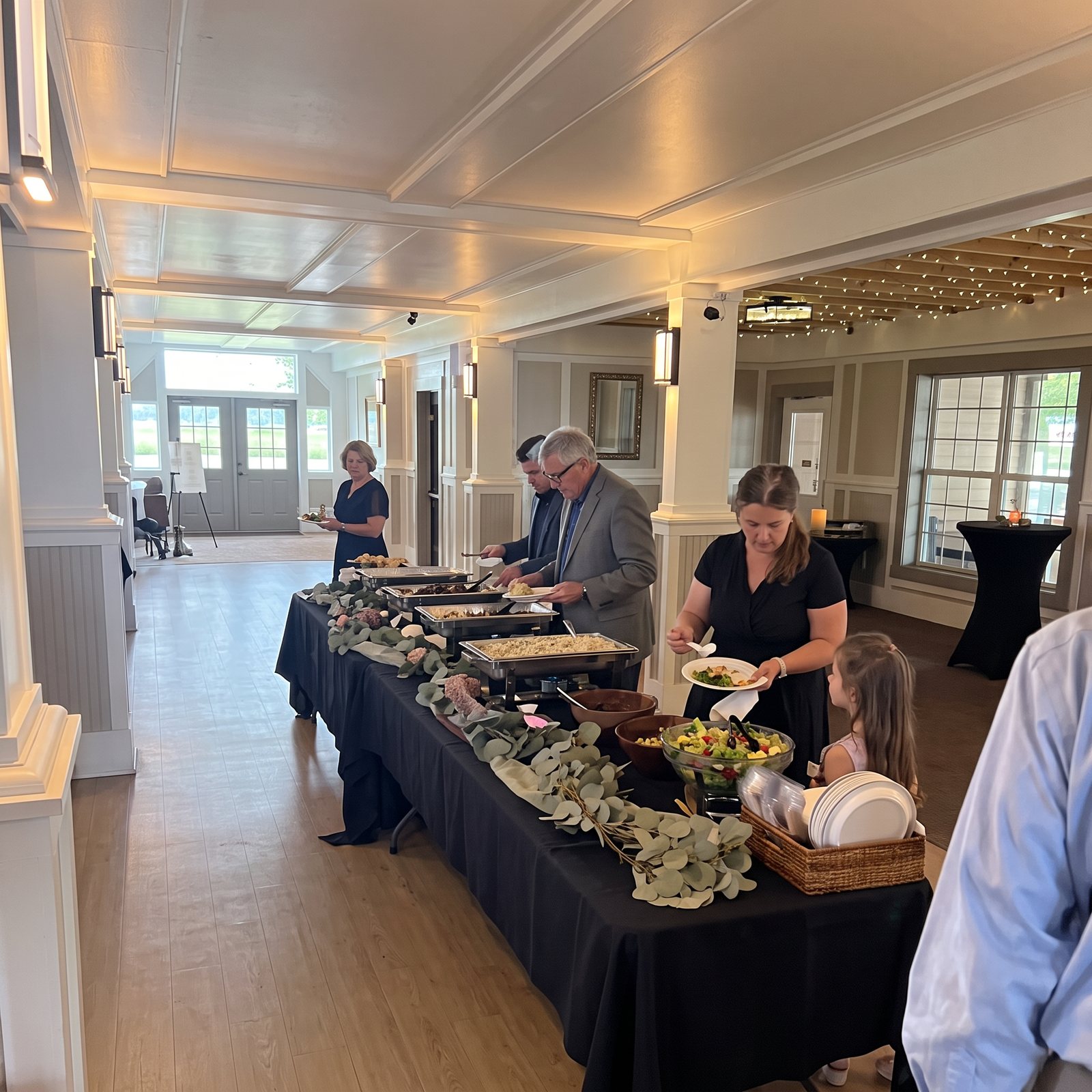 Guests serving themselves at a wedding reception buffet