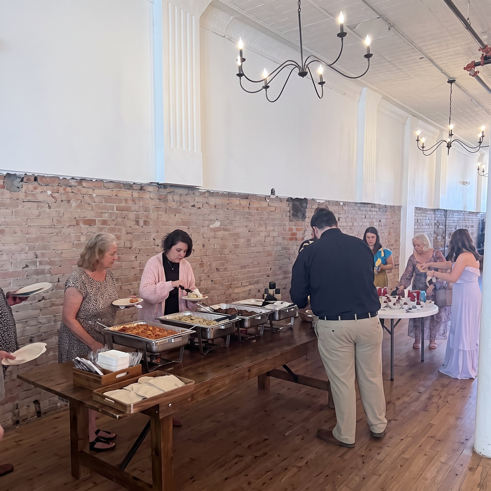 Guests being served at a brick-walled event venue